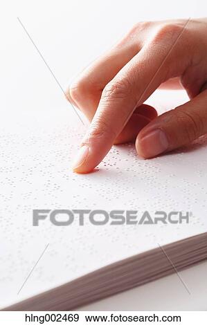 Stock Photo - Hand reading Braille paper. Fotosearch