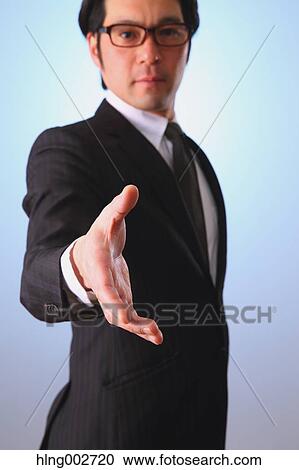 Japanese businessman giving hand View Large Photo Image Stock Image - Japanese businessman giving hand. Fotosearch