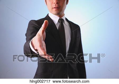 Japanese businessman giving hand View Large Photo Image Stock Photo - Japanese businessman giving hand. Fotosearch
