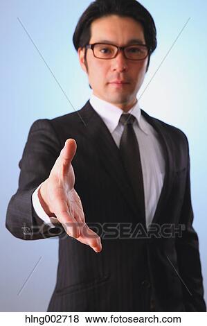 Japanese businessman giving hand View Large Photo Image Stock Photo - Japanese businessman giving hand. Fotosearch
