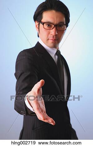 Japanese businessman giving hand View Large Photo Image Stock Photo - Japanese businessman giving hand. Fotosearch
