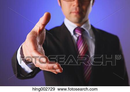 Stock Photo - Japanese businessman giving hand. Fotosearch
