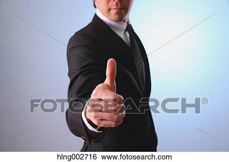 Japanese businessman giving the thumbs-up View Large Photo Image Stock Photograph - Japanese businessman giving the thumbs-up. Fotosearch