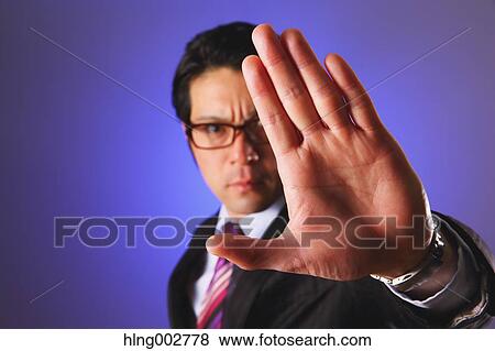 Japanese businessman giving the stop sign View Large Photo Image Stock Photo - Japanese businessman giving the stop sign. Fotosearch
