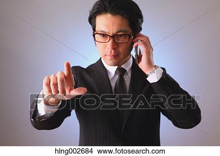 Japanese businessman using virtual reality device View Large Photo Image Picture - Japanese businessman using virtual reality device. Fotosearch
