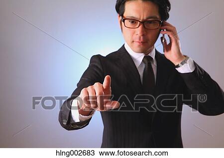 Japanese businessman using virtual reality device View Large Photo Image Stock Image - Japanese businessman using virtual reality device. Fotosearch