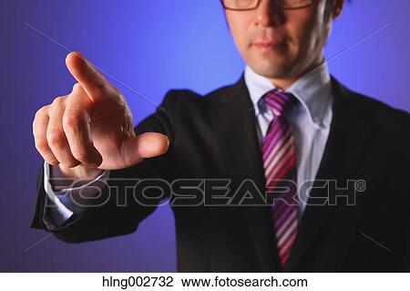 Stock Image - Japanese businessman using virtual reality device. Fotosearch