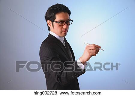 Japanese businessman using virtual reality device View Large Photo Image Stock Photo - Japanese businessman using virtual reality device. Fotosearch