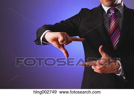 Stock Photo - Japanese businessman using virtual reality device. Fotosearch