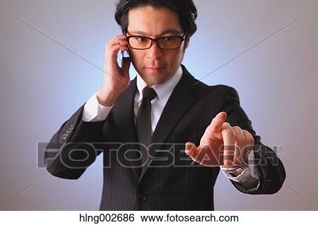 Japanese businessman using virtual reality device View Large Photo Image Stock Photograph - Japanese businessman using virtual reality device. Fotosearch