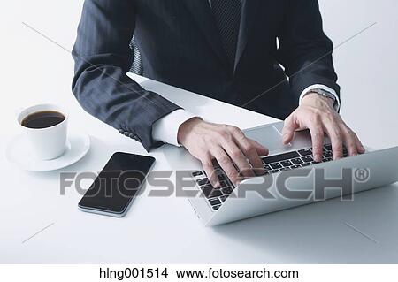 Picture - Japanese businessman working with laptop. Fotosearch