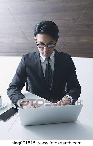 Japanese businessman working with laptop View Large Photo Image Stock Photography - Japanese businessman working with laptop. Fotosearch
