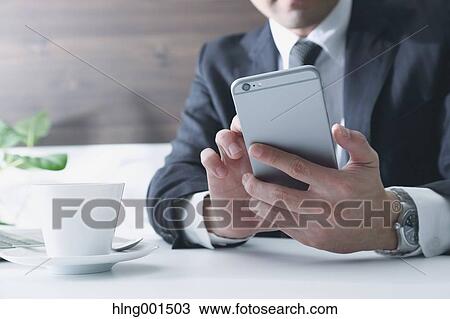 Japanese businessman working with large display smartphone View Large Photo Image Stock Image - Japanese businessman working with large display smartphone. Fotosearch