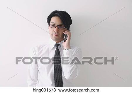 Japanese businessman working with large display smartphone View Large Photo Image Stock Image - Japanese businessman working with large display smartphone. Fotosearch