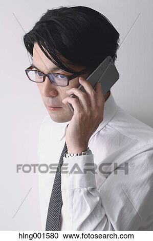 Japanese businessman working with large display smartphone View Large Photo Image Stock Image - Japanese businessman working with large display smartphone. Fotosearch