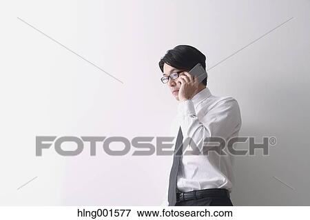 Japanese businessman working with large display smartphone View Large Photo Image Stock Photo - Japanese businessman working with large display smartphone. Fotosearch