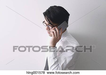 Japanese businessman working with large display smartphone View Large Photo Image Stock Photo - Japanese businessman working with large display smartphone. Fotosearch