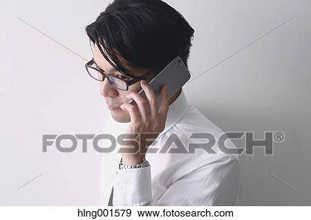 Japanese businessman working with large display smartphone View Large Photo Image Stock Photo - Japanese businessman working with large display smartphone. Fotosearch