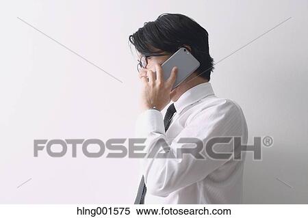 Japanese businessman working with large display smartphone View Large Photo Image Stock Photography - Japanese businessman working with large display smartphone. Fotosearch