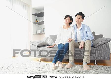 Stock Photo - Japanese couple on the sofa. Fotosearch
