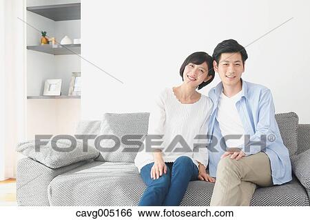 Japanese couple on the sofa View Large Photo Image Stock Photograph - Japanese couple on the sofa. Fotosearch