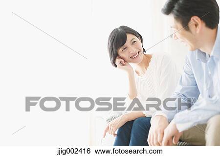 Stock Photograph - Japanese couple on the sofa. Fotosearch
