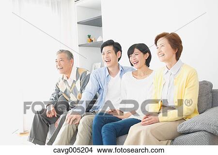 Picture - Japanese family on the sofa. Fotosearch