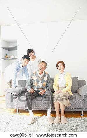 Stock Image - Japanese family on the sofa. Fotosearch