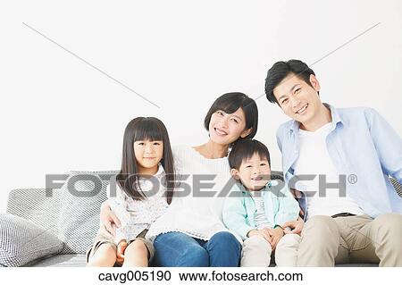 Stock Image - Japanese family on the sofa. Fotosearch