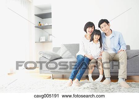 Stock Image - Japanese family on the sofa. Fotosearch