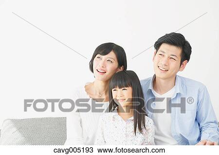 Stock Image - Japanese family on the sofa. Fotosearch
