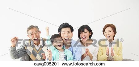 Stock Image - Japanese family on the sofa. Fotosearch