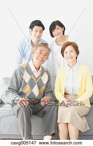 Stock Photo - Japanese family on the sofa. Fotosearch