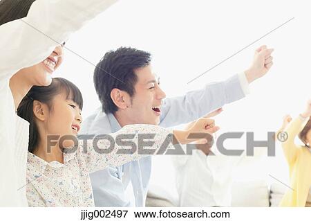 Stock Photo - Japanese family on the sofa. Fotosearch