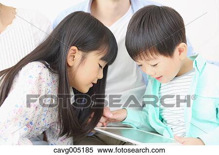 Japanese family playing with tablet View Large Photo Image Stock Photography - Japanese family playing with tablet. Fotosearch