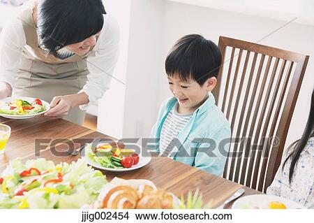 Picture - Japanese family together in the kitchen. Fotosearch