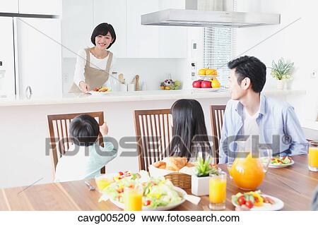 Stock Photo - Japanese family together in the kitchen. Fotosearch
