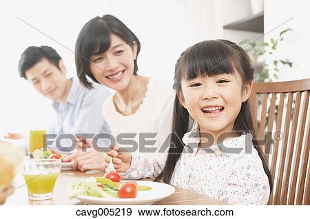 Stock Photo - Japanese family together in the kitchen. Fotosearch