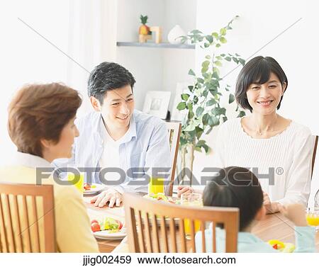 Stock Photo - Japanese family together in the kitchen. Fotosearch