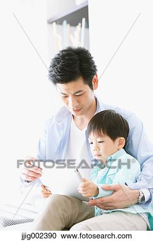 Japanese father and son on the sofa with tablet View Large Photo Image Stock Image - Japanese father and son on the sofa with tablet. Fotosearch