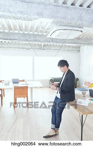 Japanese man working in modern office View Large Photo Image Picture - Japanese man working in modern office. Fotosearch