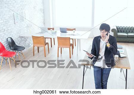Japanese man working in modern office View Large Photo Image Stock Image - Japanese man working in modern office. Fotosearch