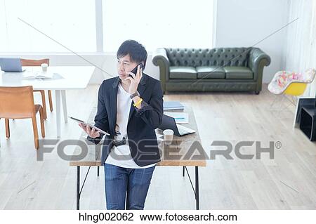 Japanese man working in modern office View Large Photo Image Stock Image - Japanese man working in modern office. Fotosearch