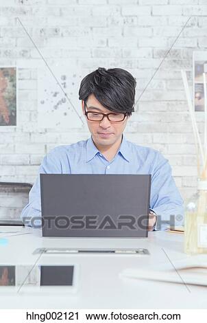 Japanese man working in modern office View Large Photo Image Stock Image - Japanese man working in modern office. Fotosearch