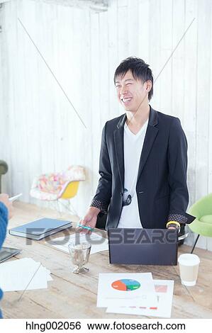 Japanese man working in modern office View Large Photo Image Stock Photograph - Japanese man working in modern office. Fotosearch