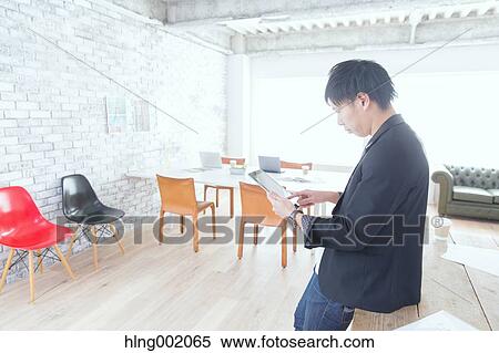 Japanese man working in modern office View Large Photo Image Stock Photography - Japanese man working in modern office. Fotosearch