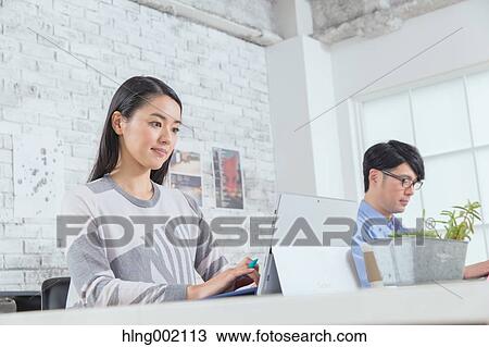 Japanese people working in modern office View Large Photo Image Stock Image - Japanese people working in modern office. Fotosearch