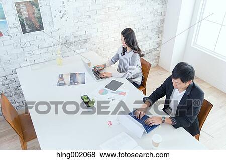 Stock Photo - Japanese people working in modern office. Fotosearch