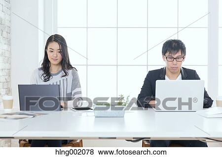 Stock Photo - Japanese people working in modern office. Fotosearch