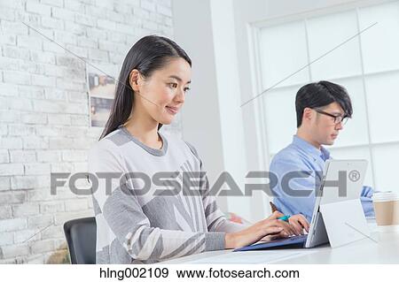 Japanese people working in modern office View Large Photo Image Stock Photo - Japanese people working in modern office. Fotosearch